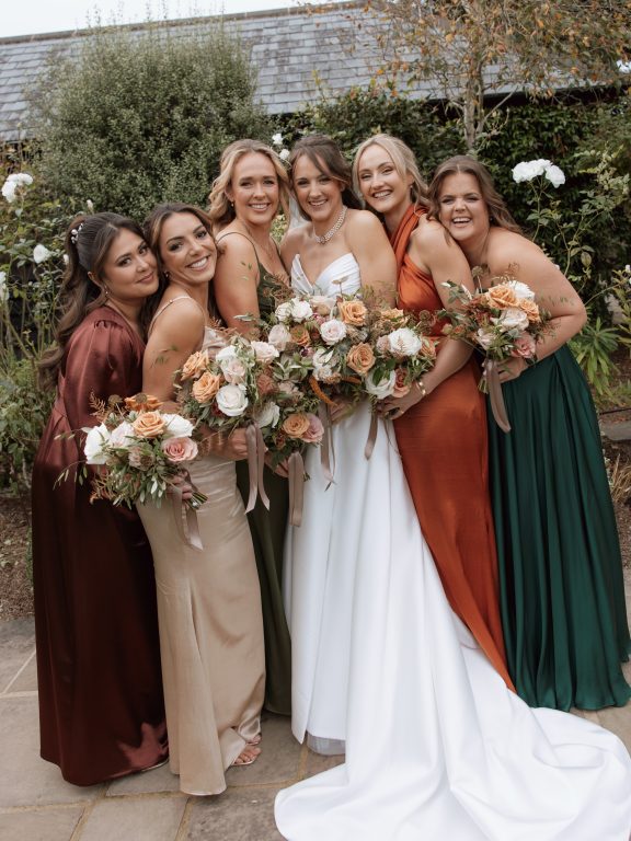 Bridal party hair styling in Surrey showing diverse hair textures with a unified romantic theme.