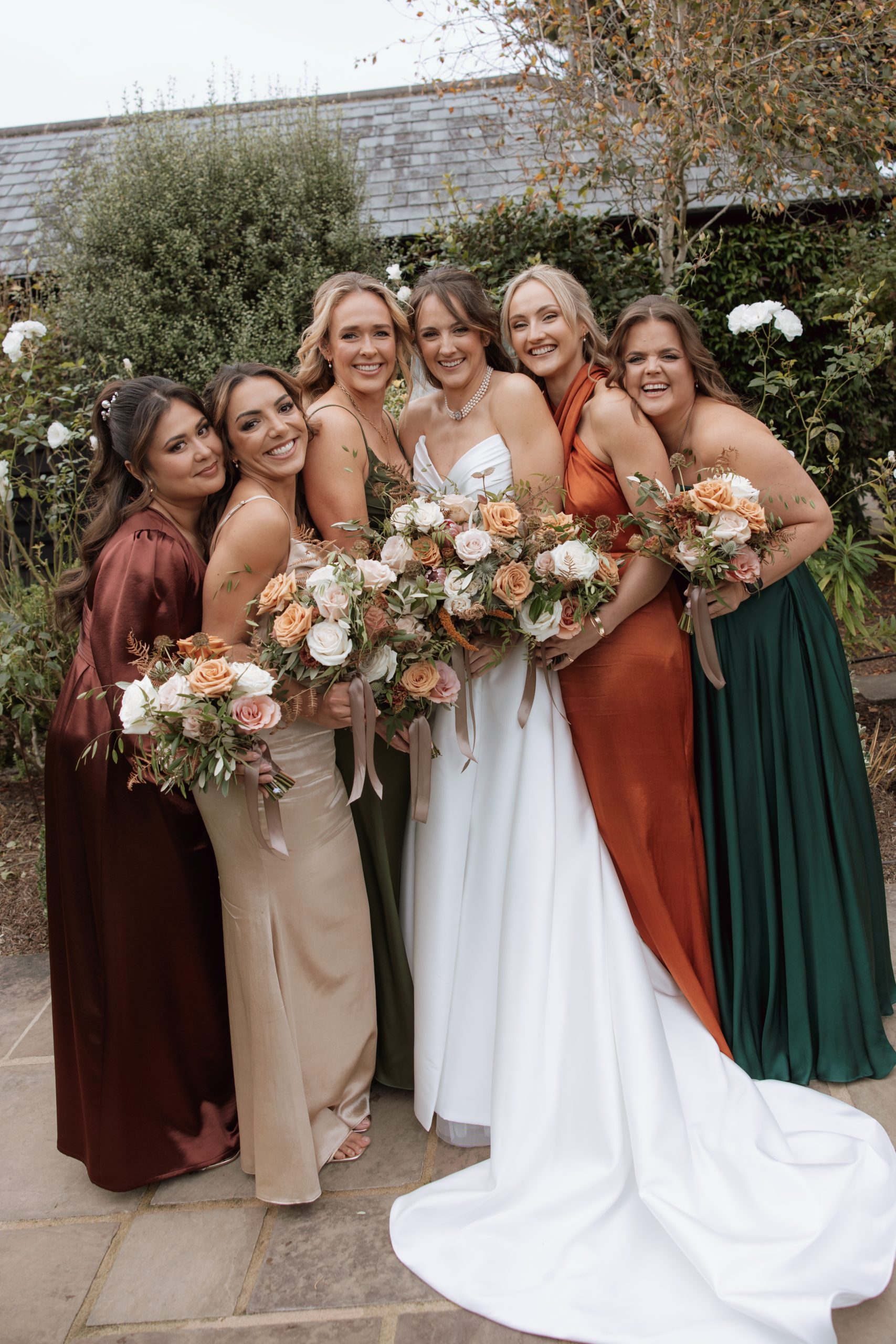 Bridal party hair styling in Surrey showing diverse hair textures with a unified romantic theme.