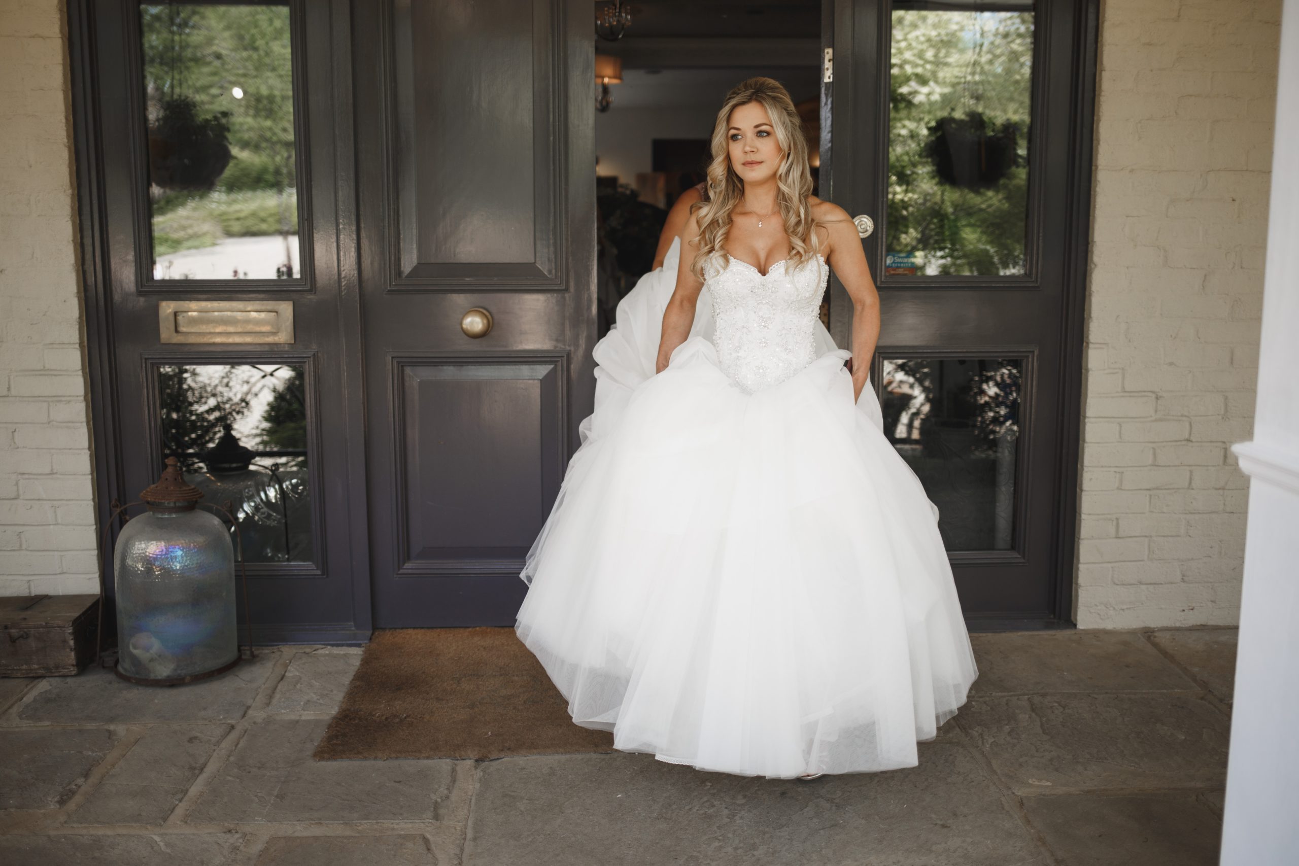 Modern romantic bridal updo with soft, face-framing tendrils for a Surrey wedding.